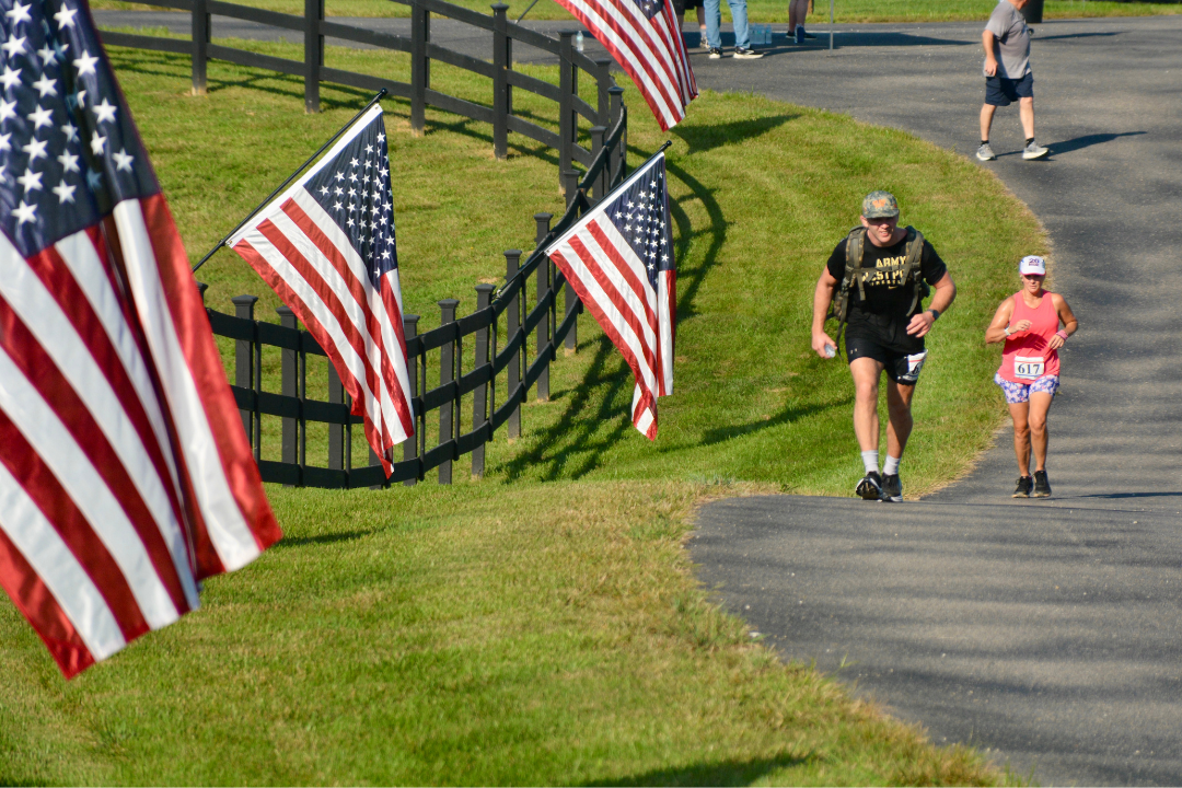 honor run man running with american flag and ruck run for ofs in huntingburg indiana at Cool Springs