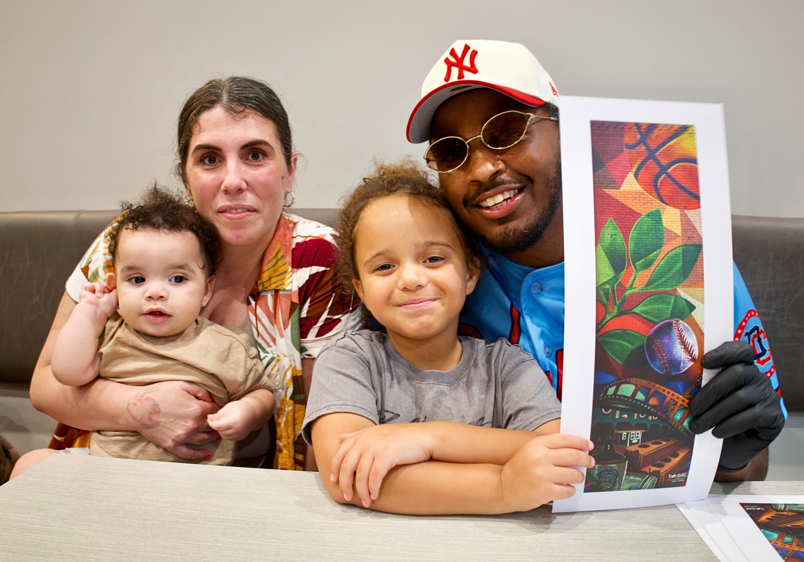 Kacy Jackson and his family pose for a picture during unveiling of Huntingburg Alleyway Mural