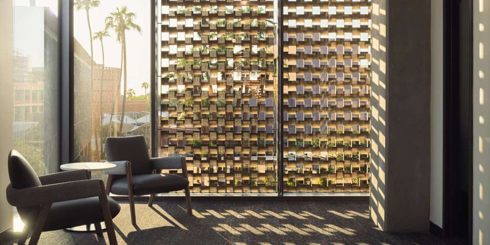 Light coming through beautiful window lattice with two lounge chairs
