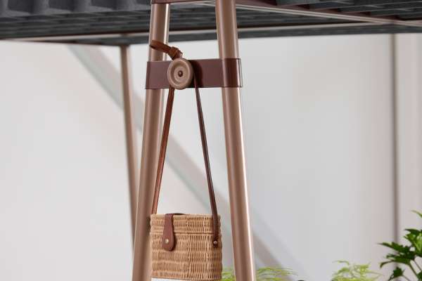 Detail of Kaleid workstation structure showing integrated bag hook, metal frame, and acoustic privacy panel