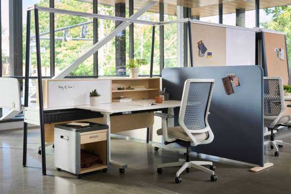 Kaleid flexible workstation system featuring privacy panels, integrated shelving, and mobile storage in an open office environment