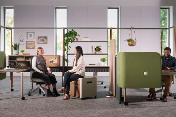 Kaleid workstation system by OFS creating neighborhood-style workspace with privacy screens, shelving, and biophilic elements