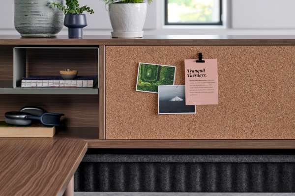 Kaleid workstation by OFS featuring integrated cork board, open storage, and biophilic elements in a flexible workplace system