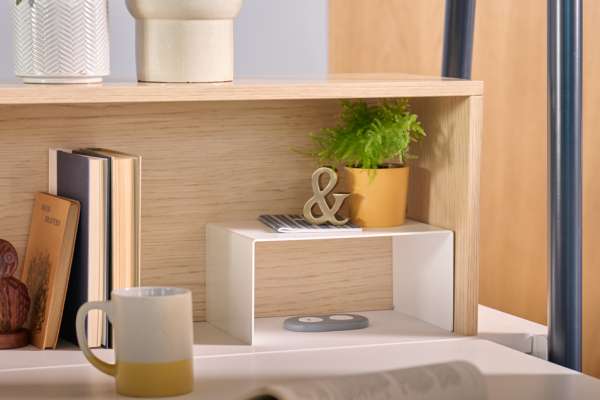 Kaleid workstation with layered shelving, storage, and space division elements in a modern office setting