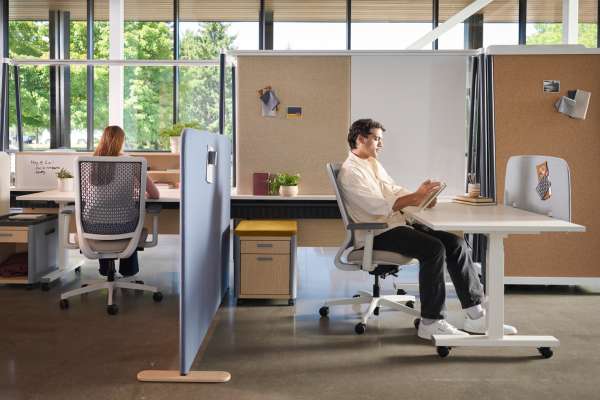 Kaleid workstation system supporting focused work with privacy panels, mobile storage, and integrated shelving in an open office plan