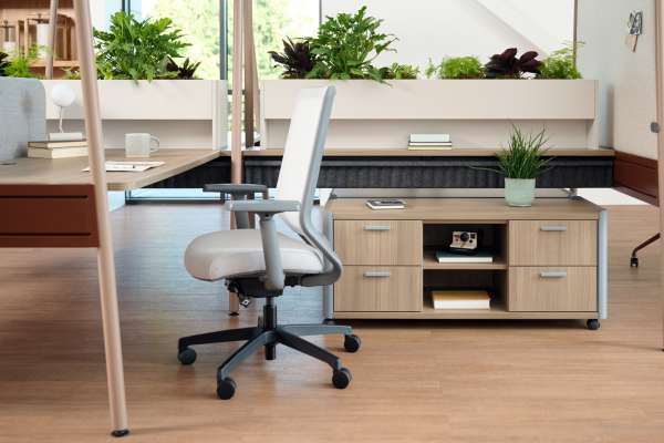 Kaleid workstation with integrated planter divider, shared work surfaces, and storage supporting a flexible workplace layout