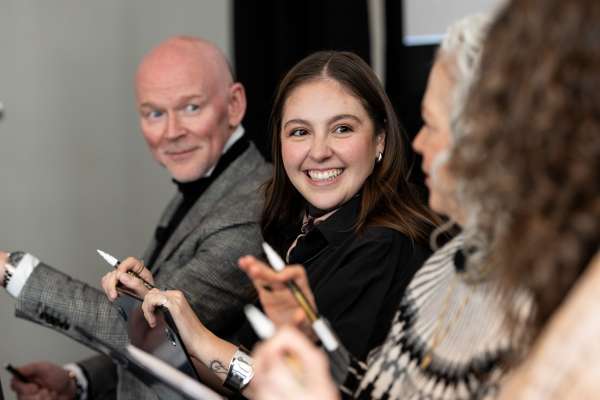 Design professionals in a small group discussion at IIDA Industry Roundtable, collaborating on workplace design ideas