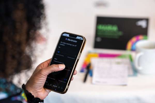 Maria VanDeman using mobile polling tool during a workplace design workshop to share feedback in real time