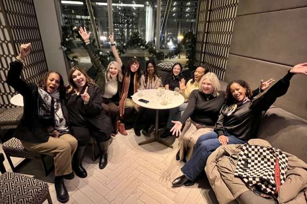 Maria VanDeman and group of design professionals celebrating and engaging together during industry roundtable event