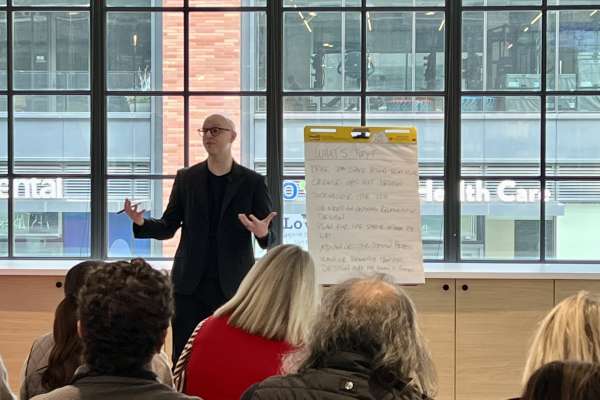 Speaker presenting workplace innovation concepts during design workshop session