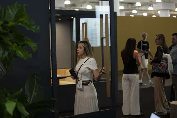 Woman exploring ROOM Phone Booth at ICFF 2026.