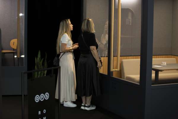 Two women discuss and explore ROOM booth at ICFF 2026.
