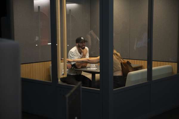 Two people meeting inside ROOM booth at ICFF 2026.