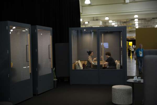 People meeting in ROOM Phone Booth at ICFF 2026.