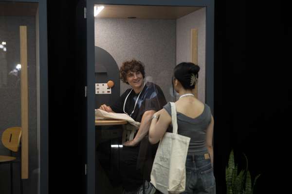 People meeting in ROOM Phone Booth at ICFF 2026.