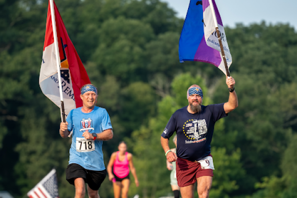 people-holding-flags-running-honor-and-remember-run