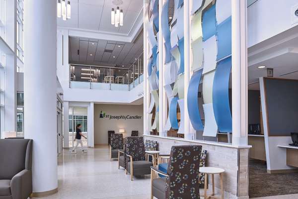 Medical center waiting area in hallway with large windows