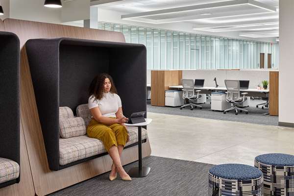 Private seating area behind rows of office desks