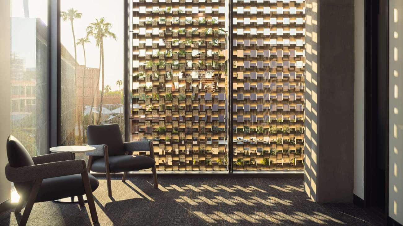 Light coming through beautiful window lattice with two lounge chairs