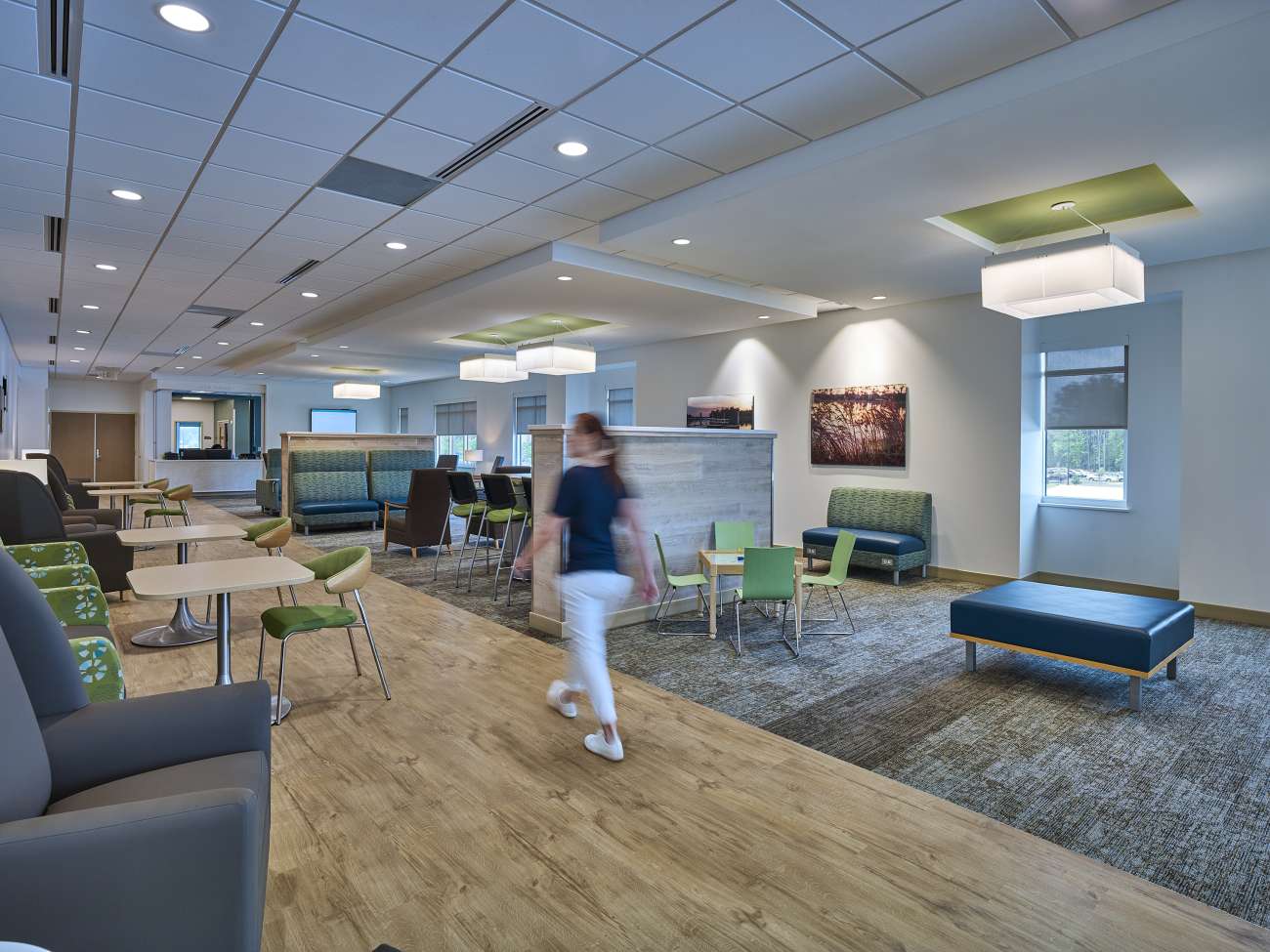 Medical center waiting area with woman walking through