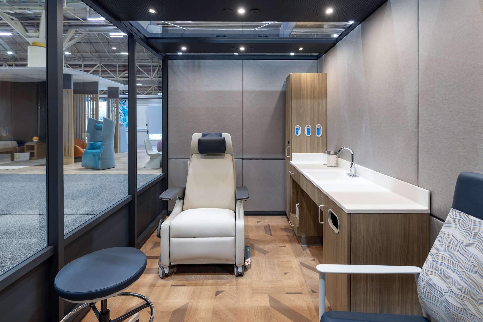 Exam room setting with mile market modular cabinetry and along with a Lasata Recliner and offshore patient seating AT HCD