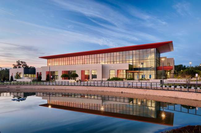 Wellness Center with pond out front at sunset